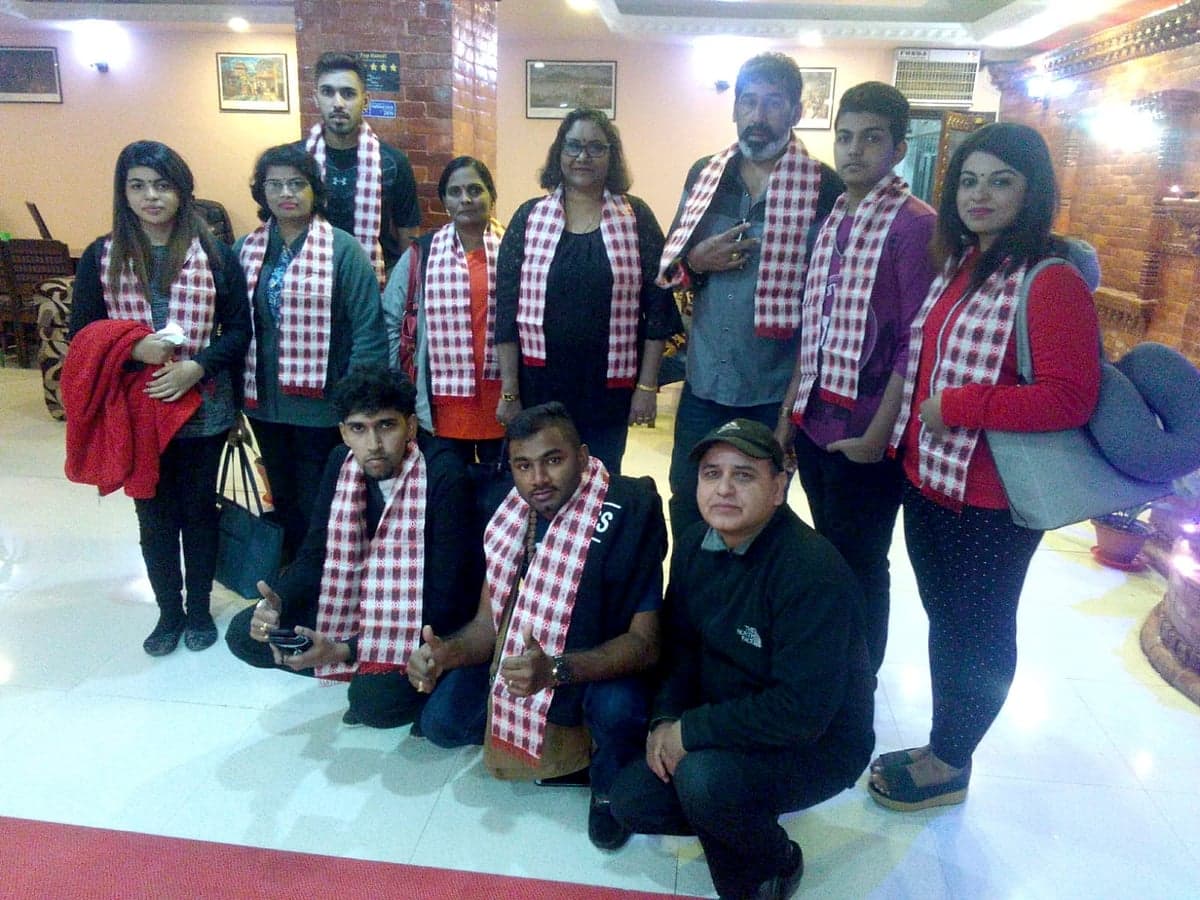 Greeting a group with traditional Nepali welcome scarves